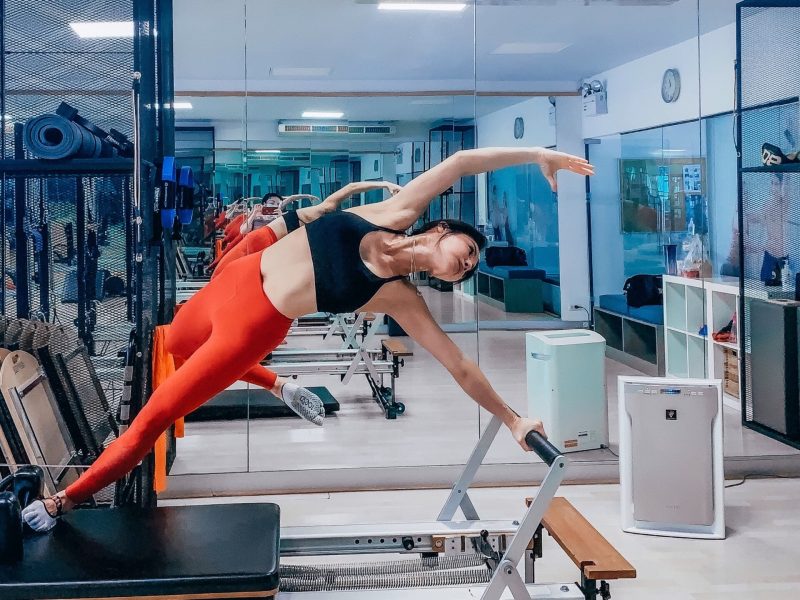 a-healthy-woman-doing-pilates-on-a-reformer-equipm-2021-12-26-17-42-36-utc-scaled.jpg