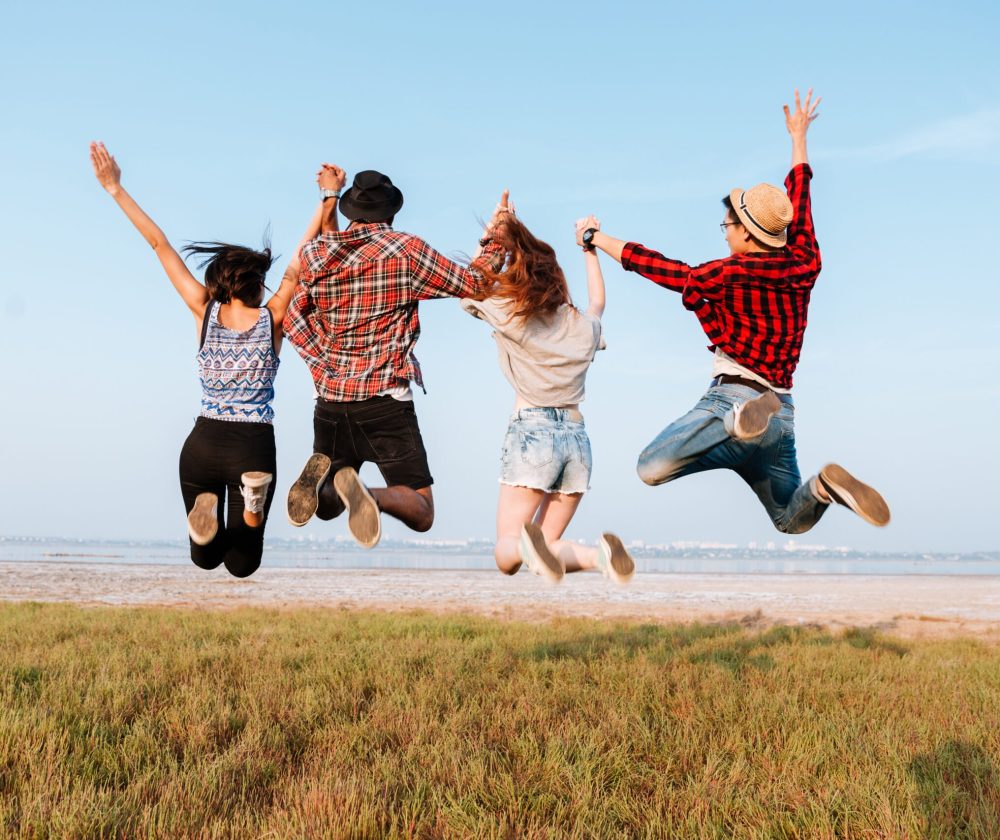 back-view-of-happy-people-jumping-in-the-air-outdo-2021-08-26-18-20-06-utc-scaled.jpg