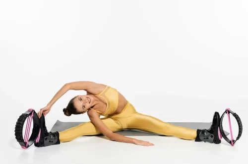 flexible-woman-in-active-wear-exercising-on-fitness-mat-kangoo-jumping-shoes-toned-body-sport.webp