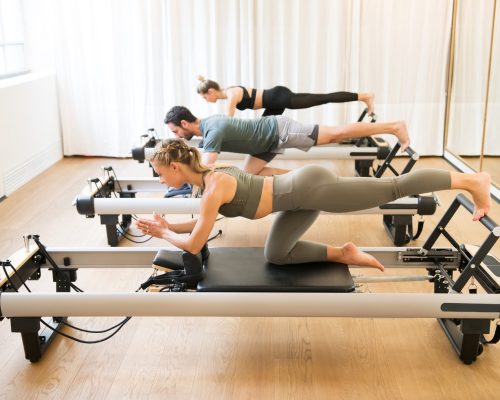 friends-doing-pilates-kneeling-glutes-exercises-2021-08-26-22-34-27-utc-scaled.jpg