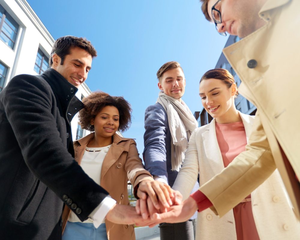 group-of-happy-people-holding-hands-in-city-2022-10-07-03-14-53-utc-scaled.jpg