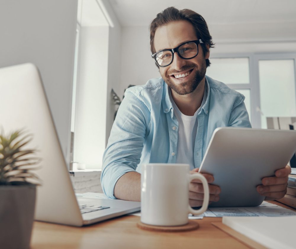 happy-young-man-using-technologies-while-sitting-a-2022-09-29-20-04-09-utc-scaled.jpg