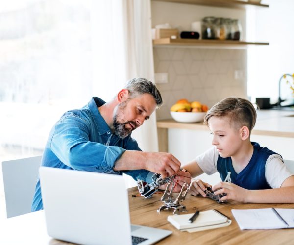 mature-father-with-small-son-sitting-at-table-indo-2021-08-27-16-22-19-utc-scaled.jpg