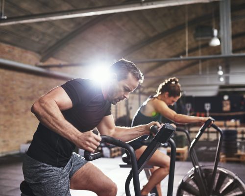 sportsmen-working-out-hard-on-cycling-machines-2021-08-26-17-26-42-utc-scaled.jpg